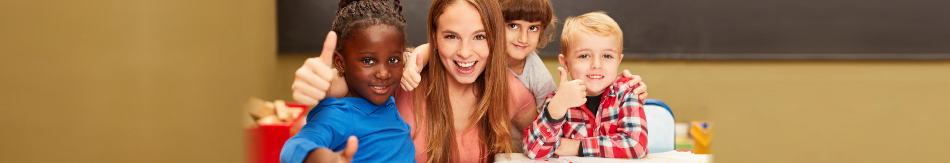 Happy children in multicultural kindergarten keep their thumbs up